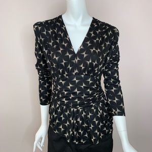 V-neck unique shoulder design long sleeve shirt.
